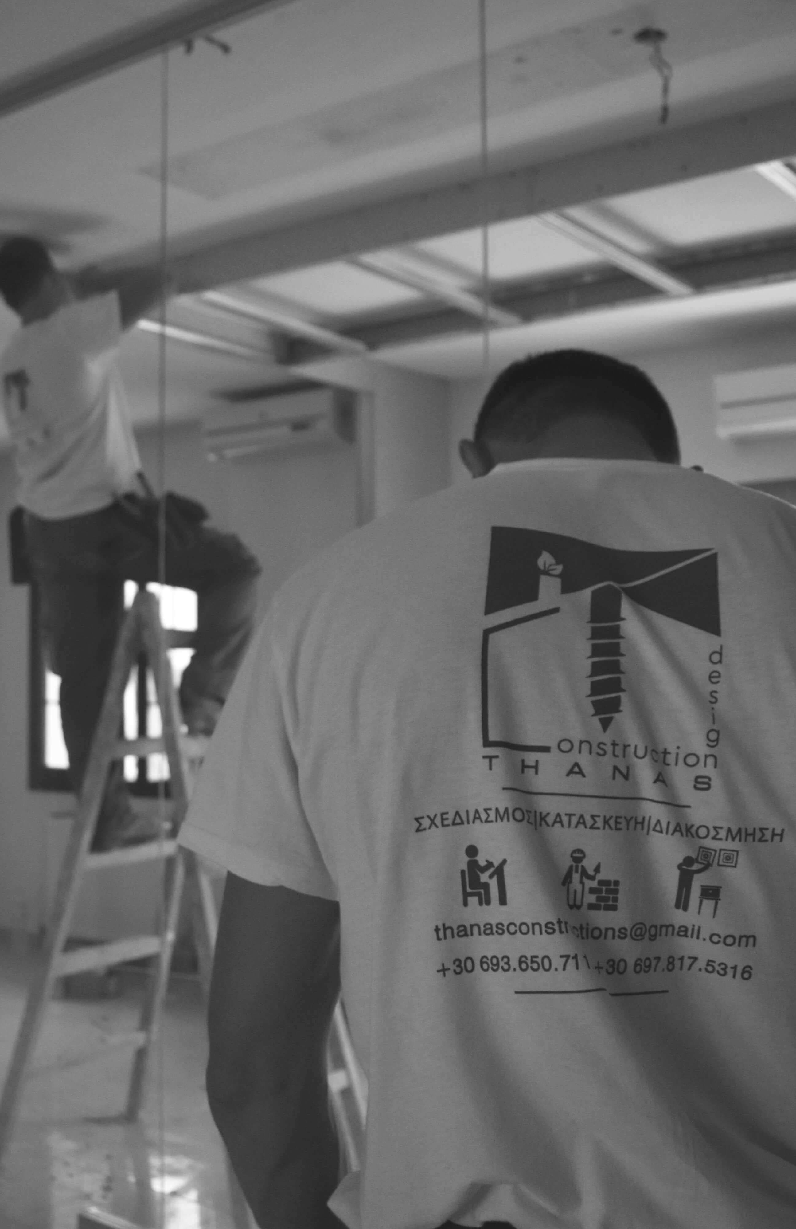 Construction worker installing drywall - mobile view